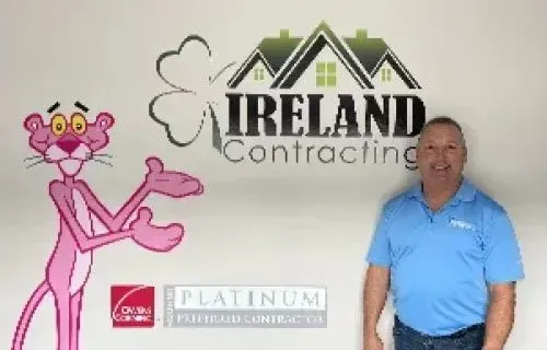Gary Ireland, owner of Ireland Contracting, standing in front of the company logo.